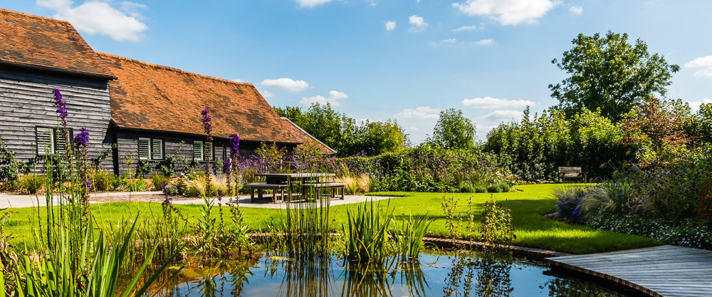 An image showing a round lake in a garden.