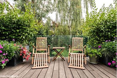 Image of two deckchairs in a garden. 
