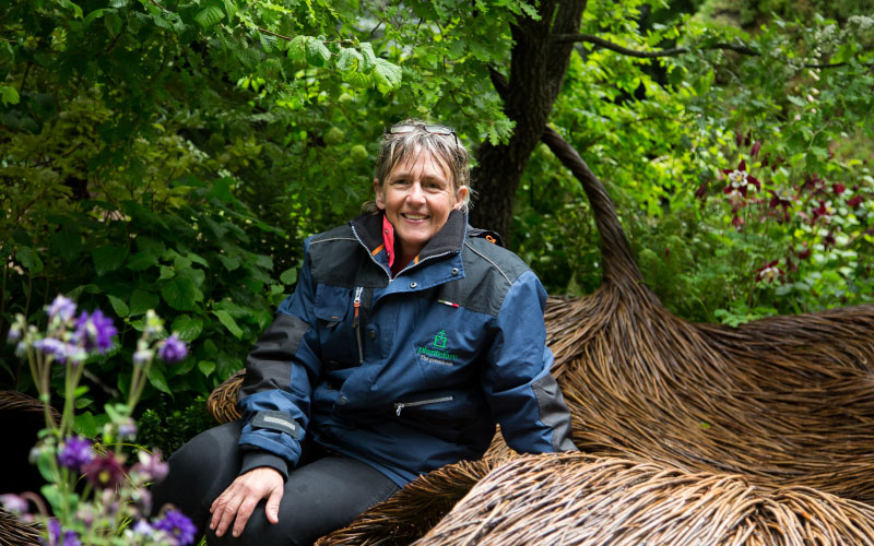 Sarah Eberle RHS Chelsea sitting in the garden she designed in 2016